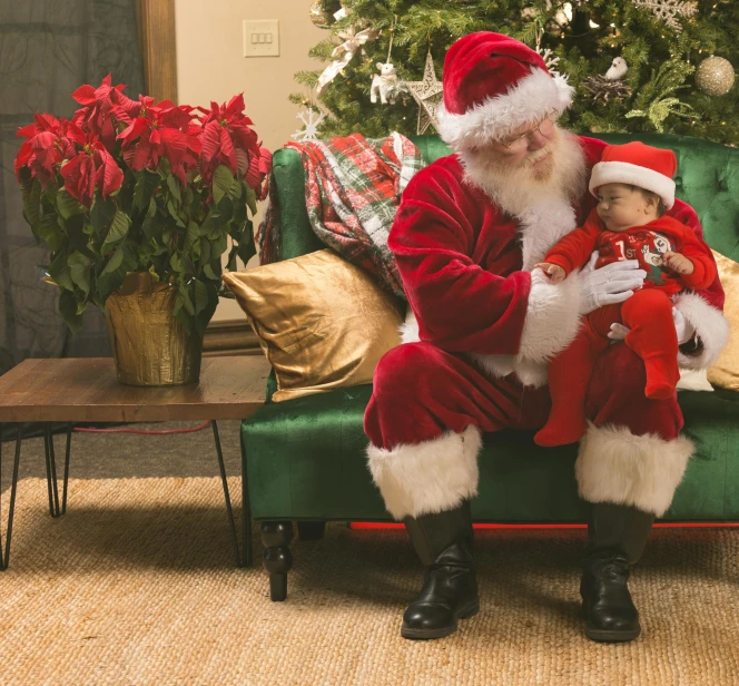 a man in a santa suit sitting with a child