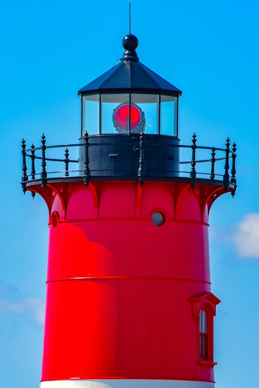 a red light house on a sunny day