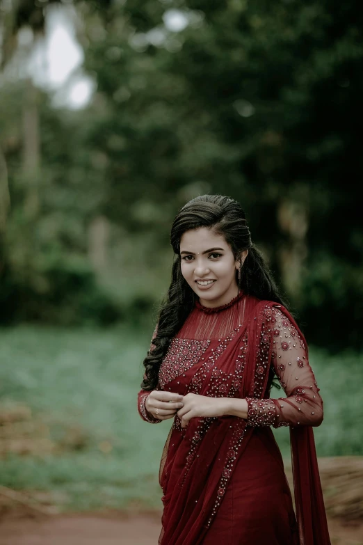 a beautiful woman in red dress and jewellery smiling