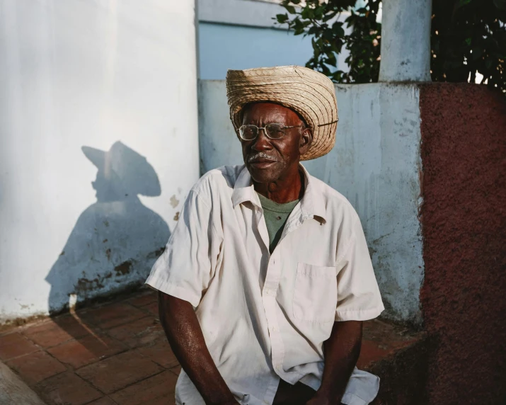 an old man is wearing a straw hat