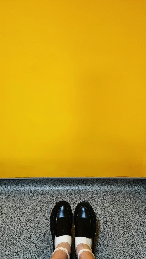 woman's feet wearing loafers standing on the step