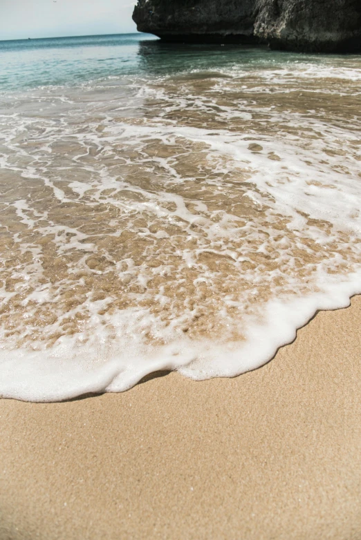 wave crashing on the beach and the cliffs