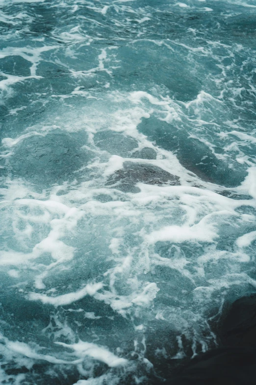 a view of a body of water with waves