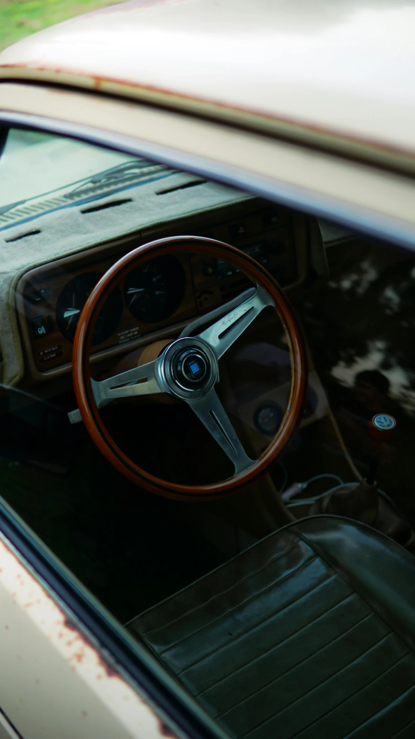 the interior of an old, burnt - out car with wood grain flooring and steering wheel