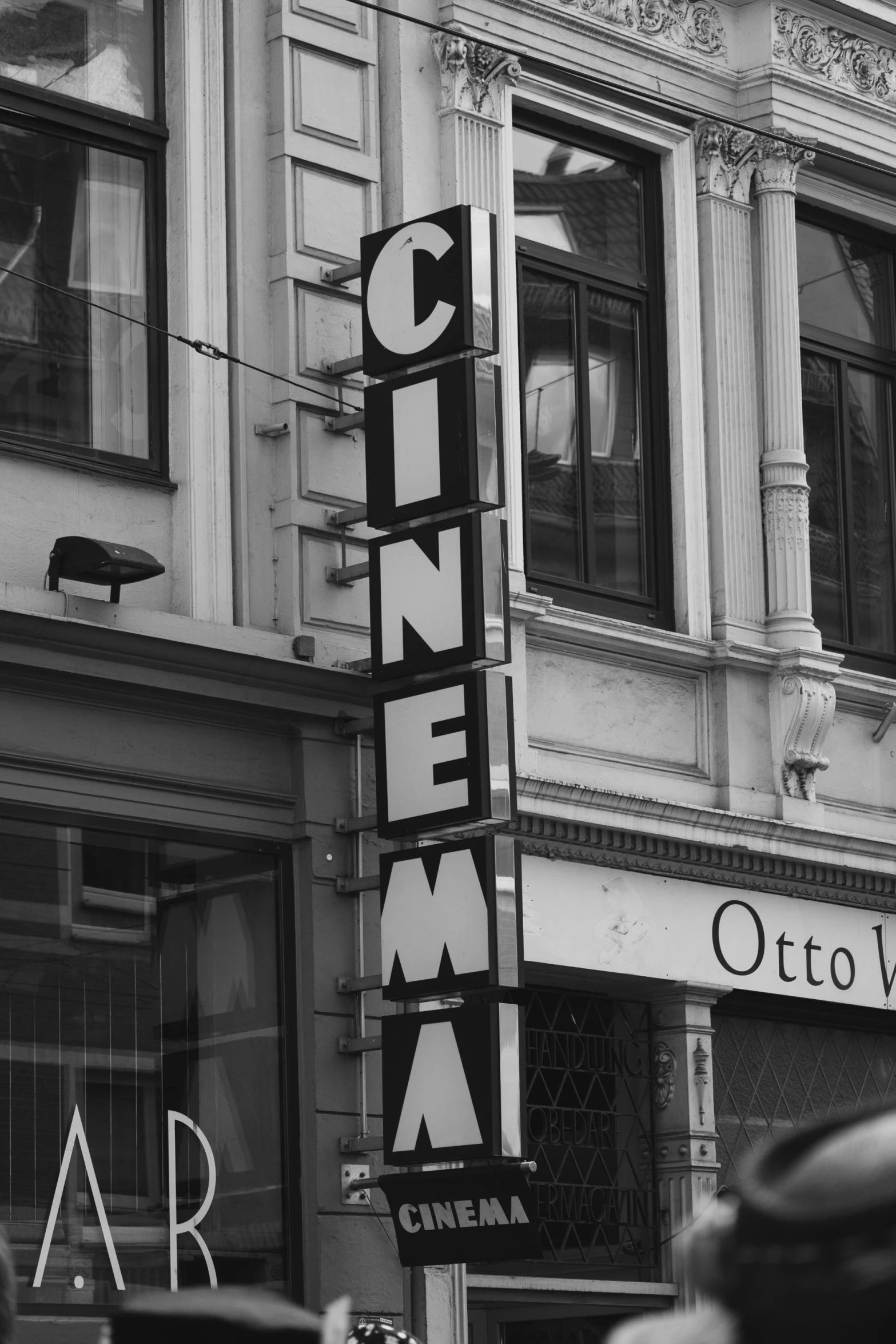 a sign for a cinema on the side of a building