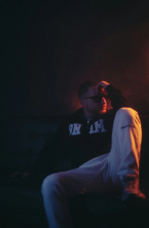 a person sitting on a chair next to a lit candle