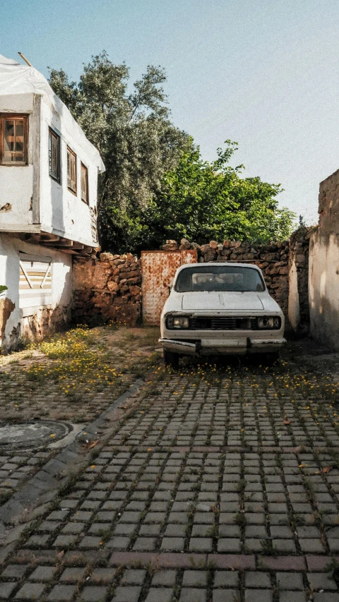 an old white car parked on the street