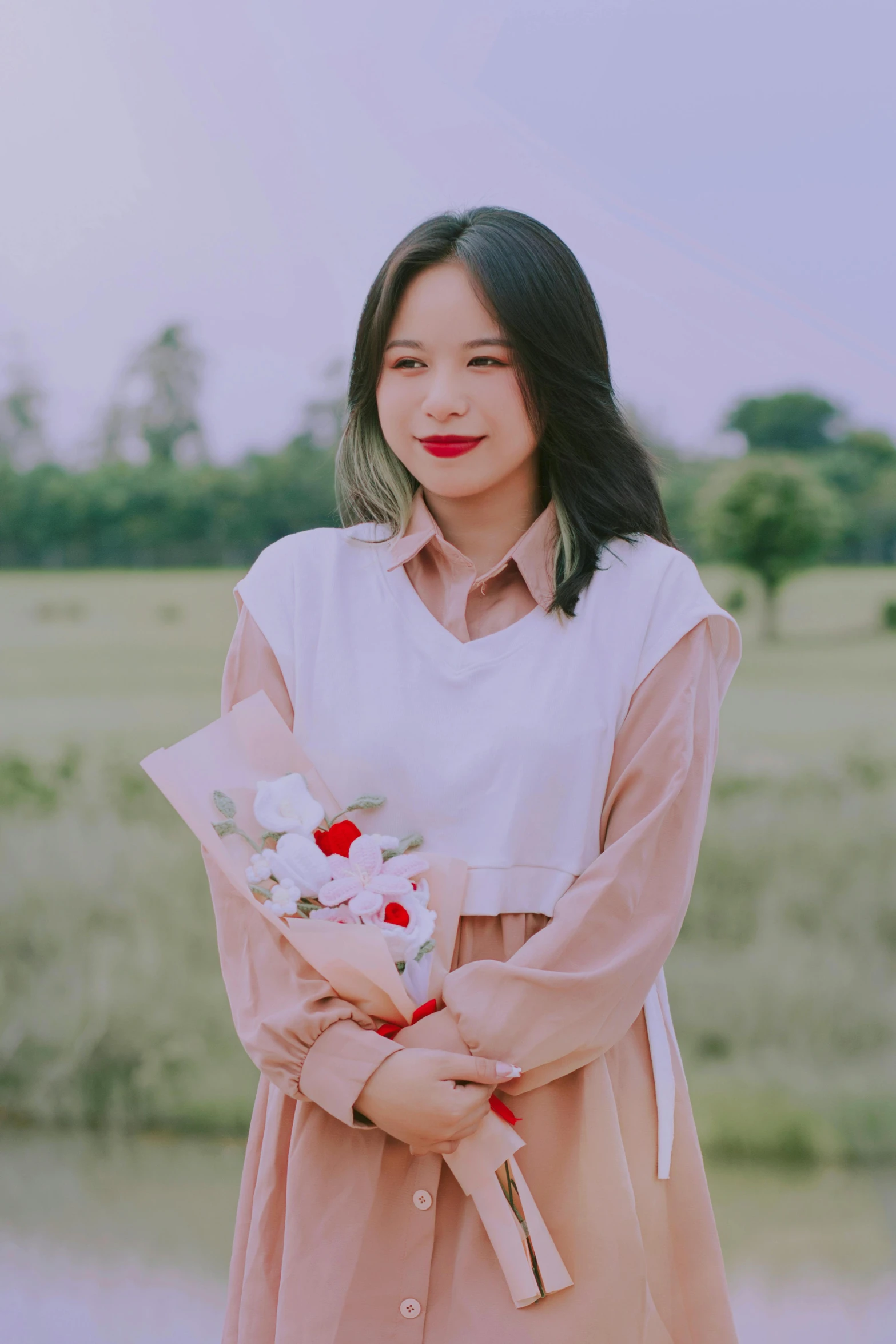 a woman holding flowers and a bouquet standing