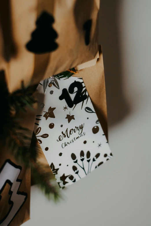 a white and brown gift bag with black numbers on it