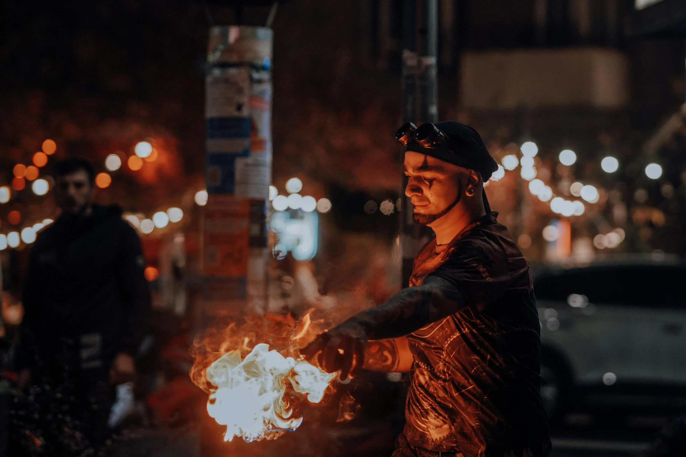 a man holding a burning object while wearing a hat