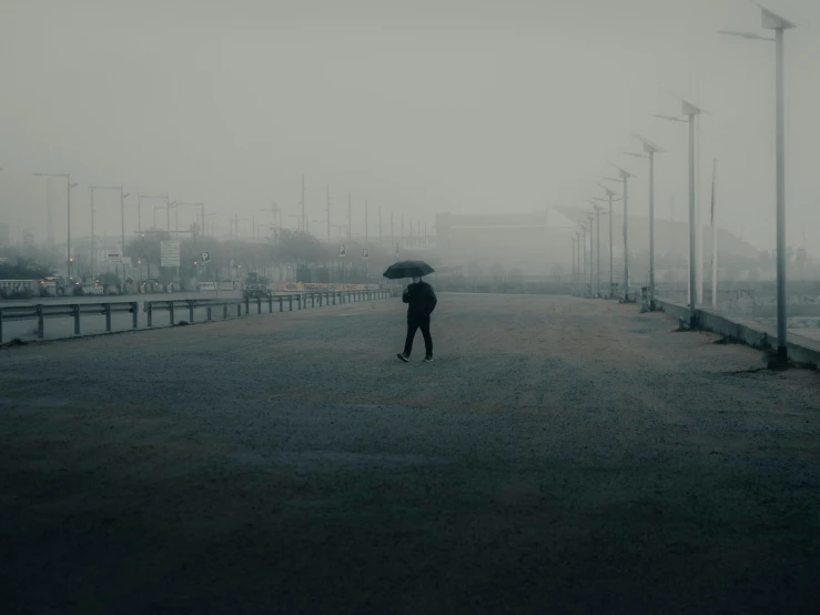 a person standing under an umbrella while holding an umbrella