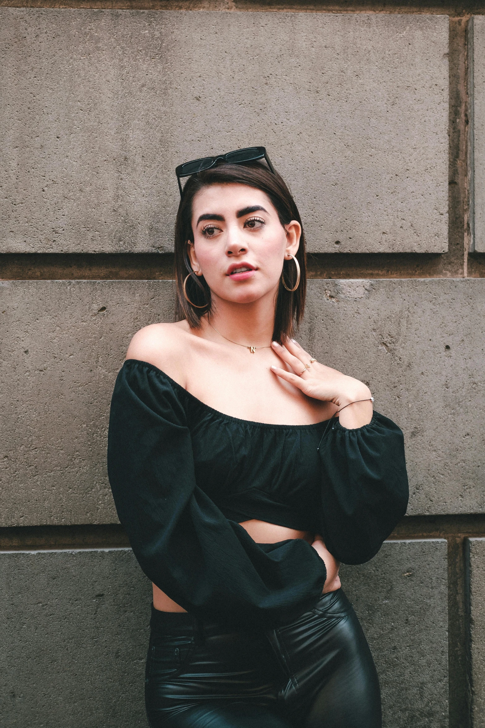 a woman in leather pants and a black top