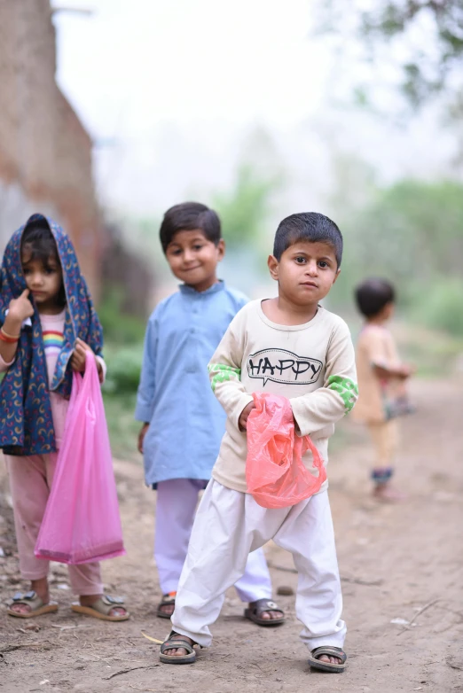 a group of children standing around one another