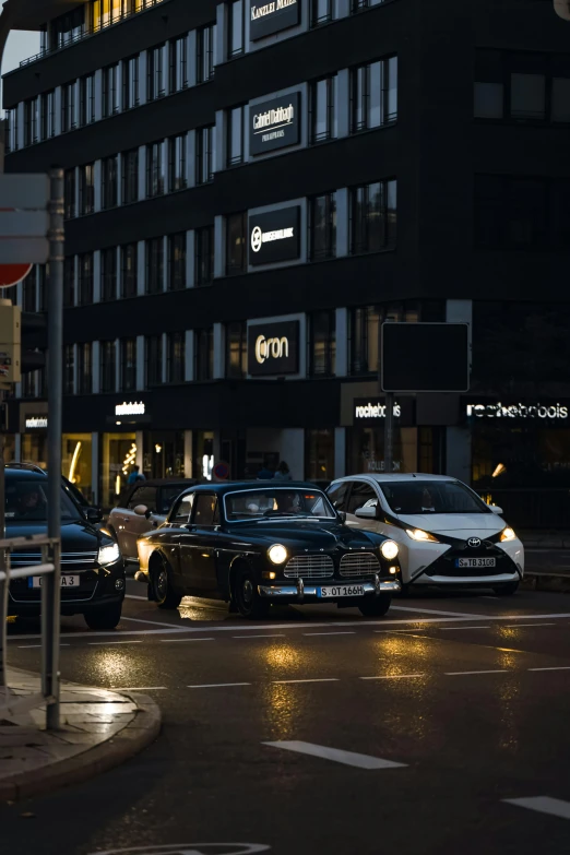 a couple of cars sit parked in the street