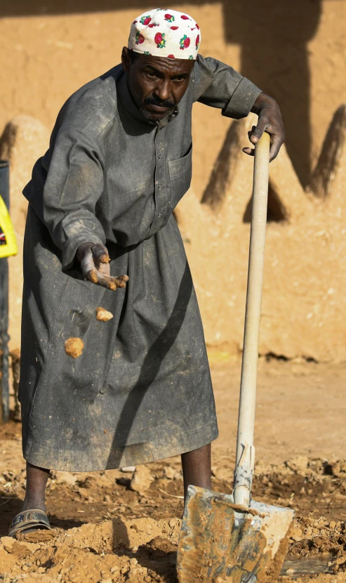 a person that is using a shovel in the dirt