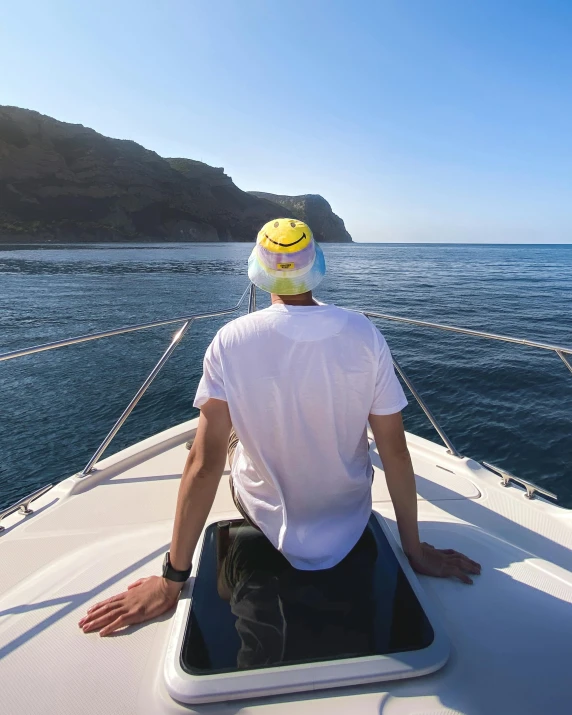 man sitting on a boat with his hand on the handle