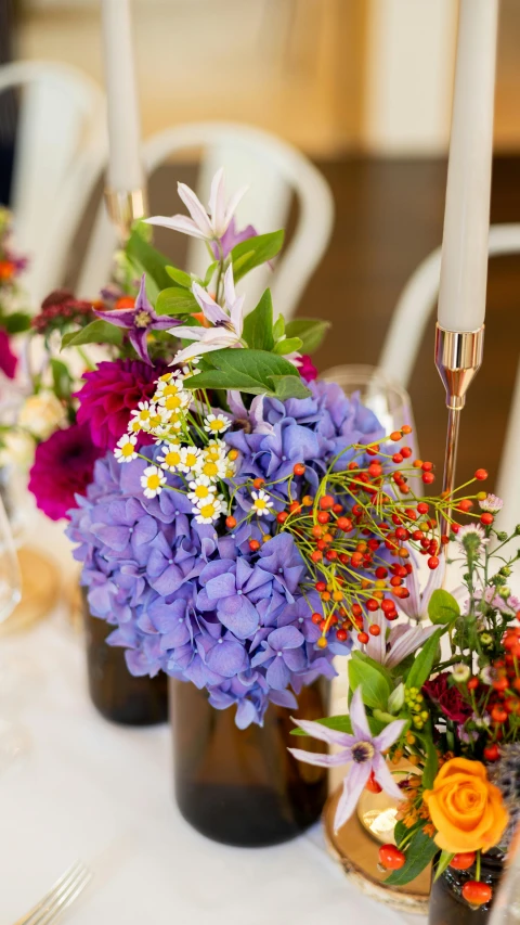 flowers and candles sitting on the center table