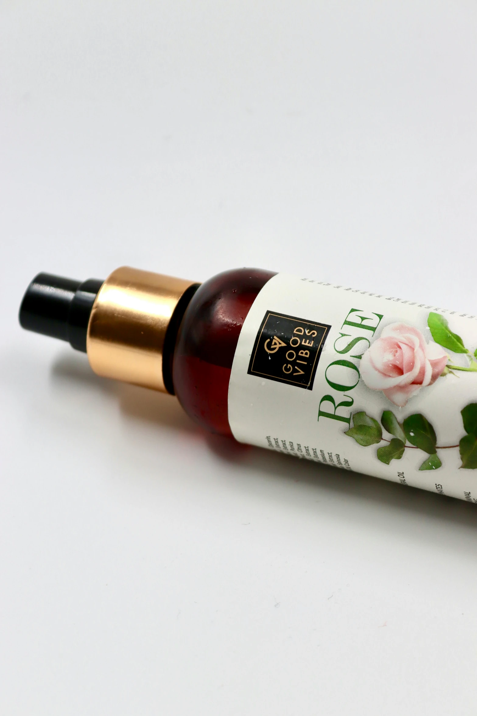 a bottle of hair conditioner that has a flower on it