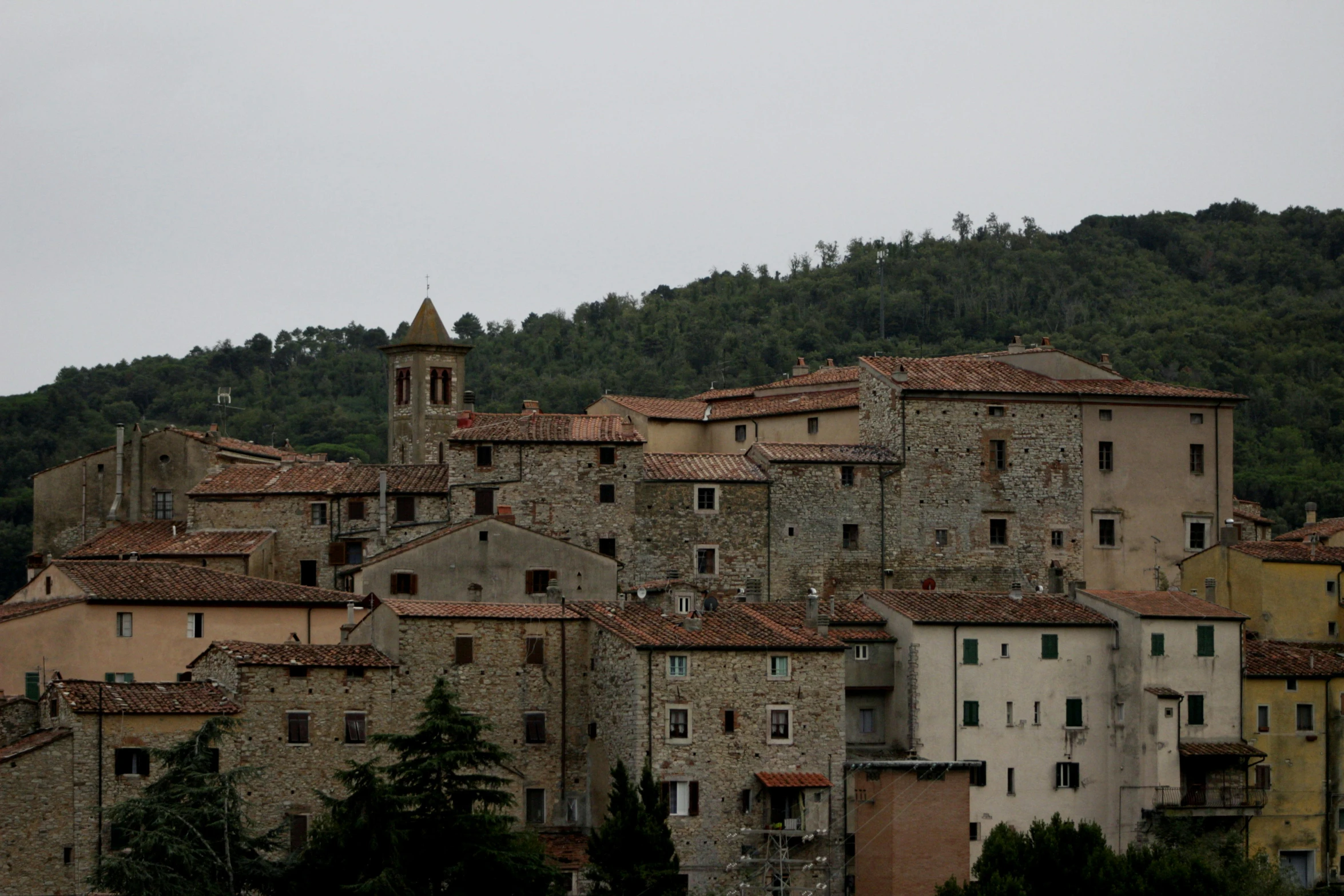 a town with stone buildings in front of a mountain