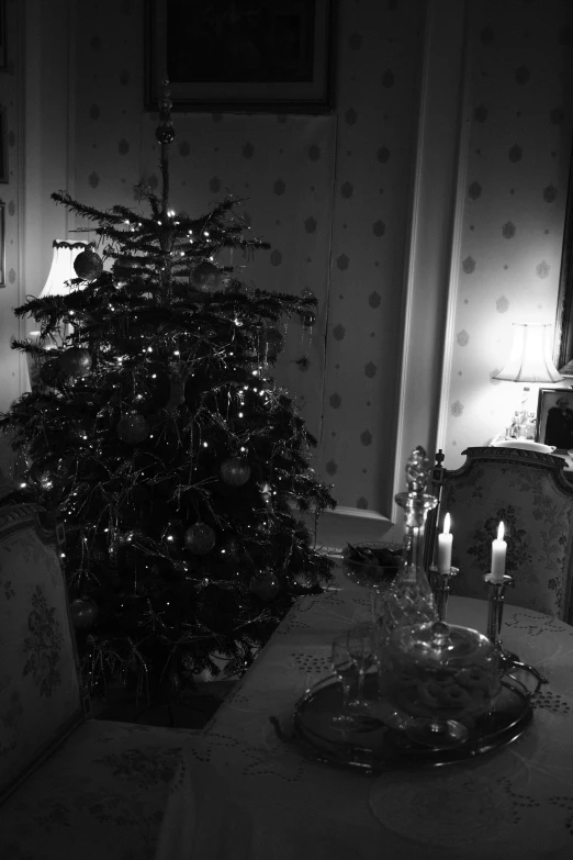 a dark living room with christmas trees in the corner