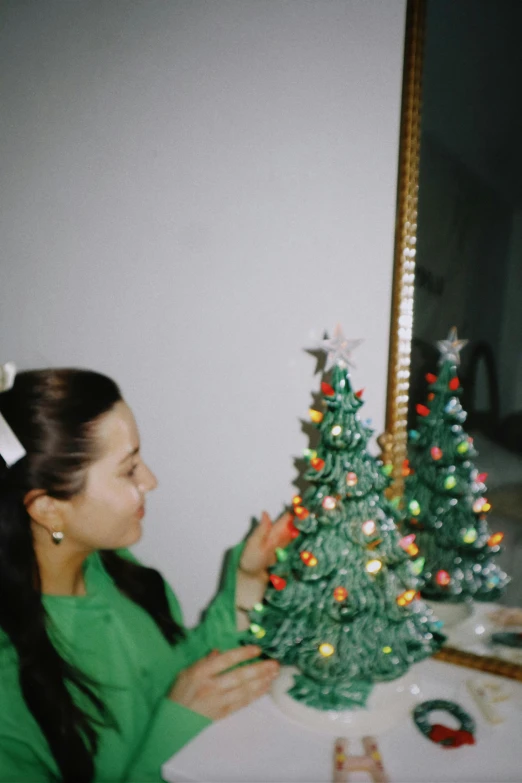 a woman looks at the christmas tree