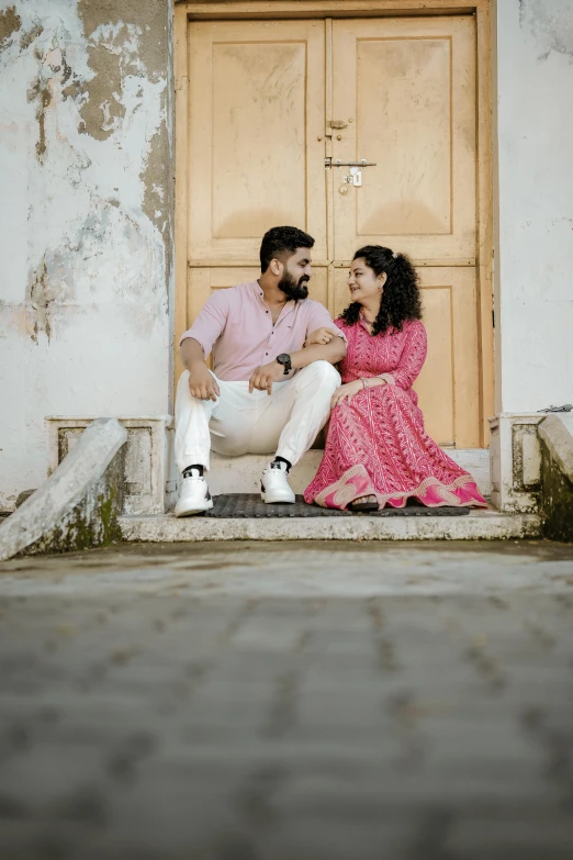 a couple on the steps of a building looking at each other