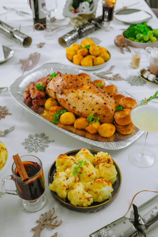 a table filled with assorted foods and glasses of liquid