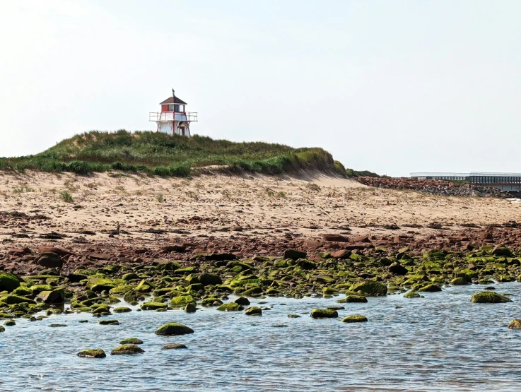 lighthouse overlooking the ocean on top of an island