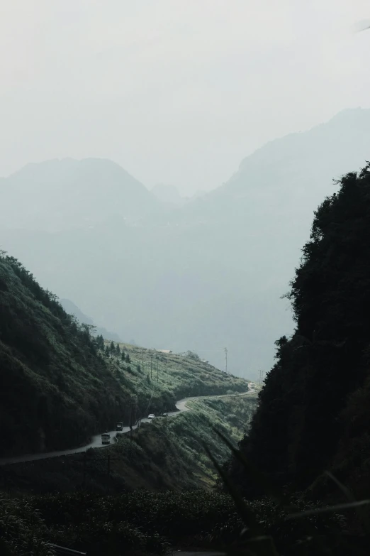 a landscape of mountains, road and trees