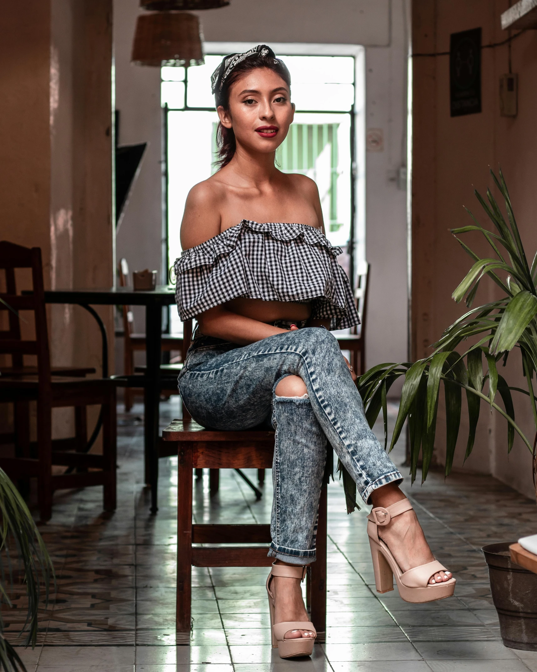 a beautiful young woman sitting in a chair