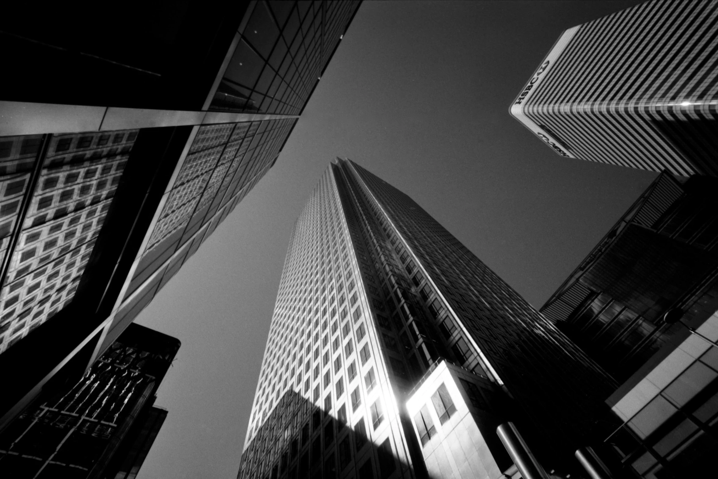 high rise buildings stand in the center of a black and white image