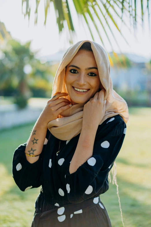 a woman with her hand on the neck and smiling