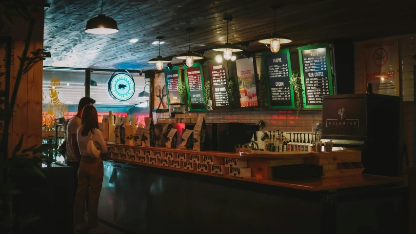 person standing behind the counter of a restaurant