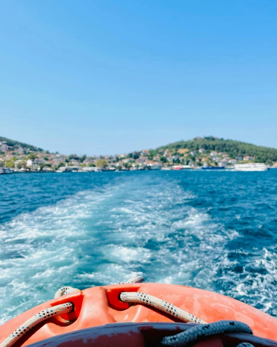 an orange raft is driving through the water