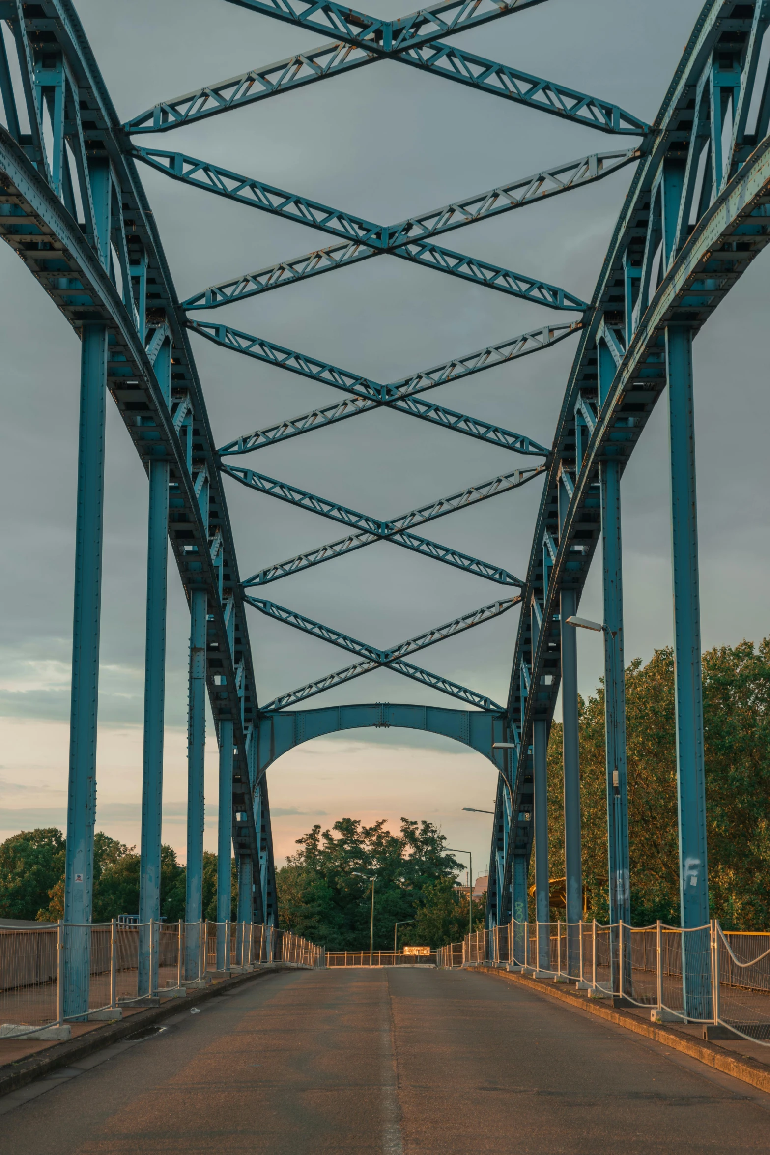 a long blue steel bridge over a street