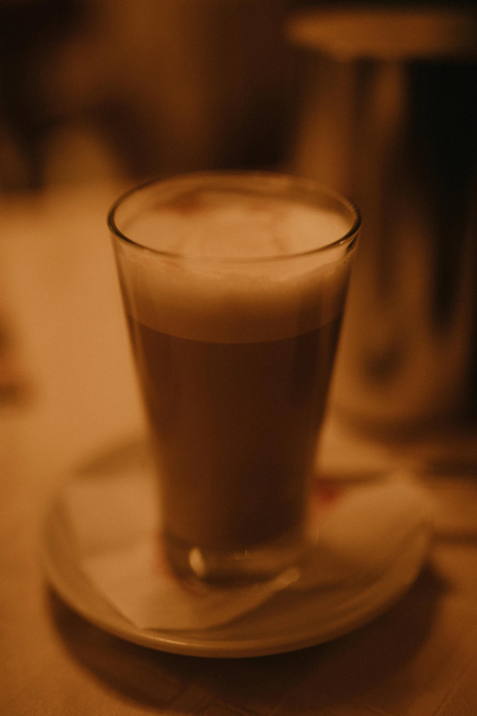 the image is blurry of a beverage on the saucer