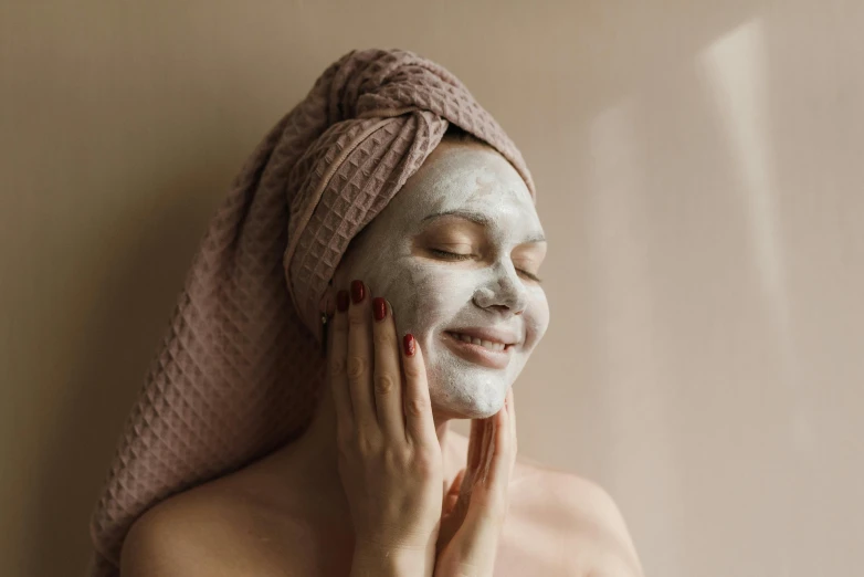 a woman wearing a towel on her head and face