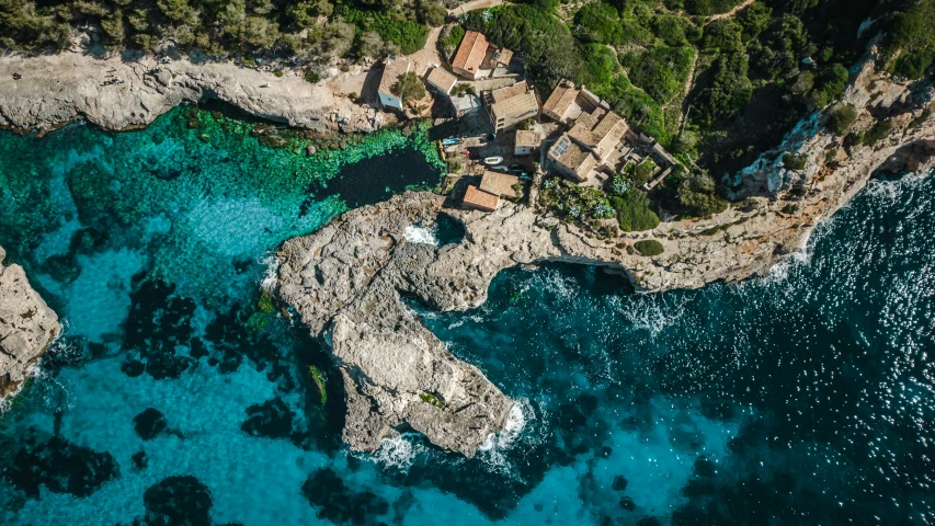 an aerial view of a mansion on the coast