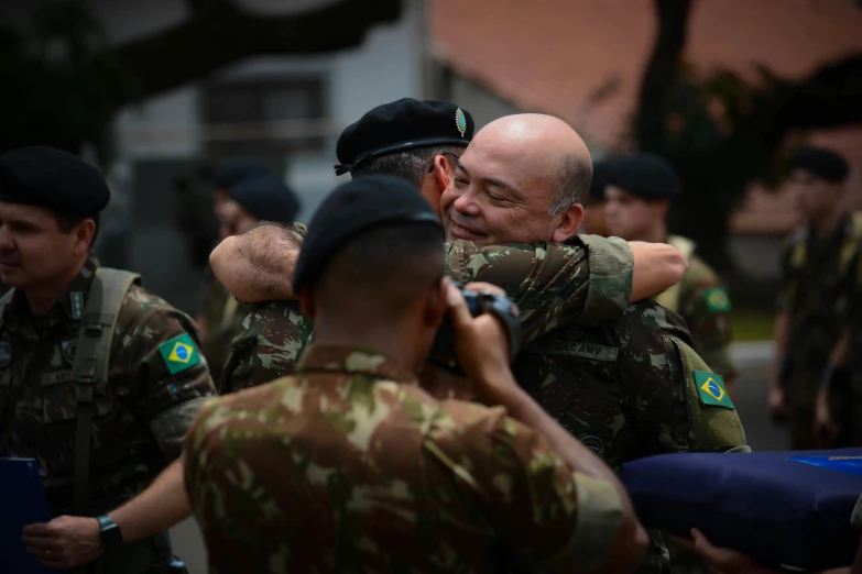 a military group is talking and laughing together