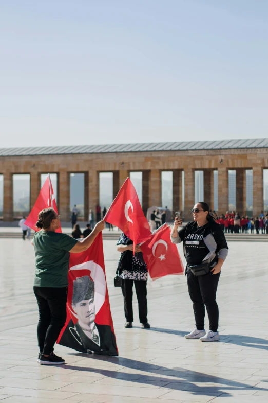 a group of people holding flags in a square