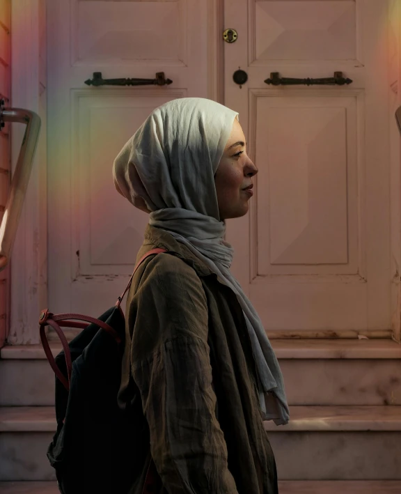 woman walking past the door of a building