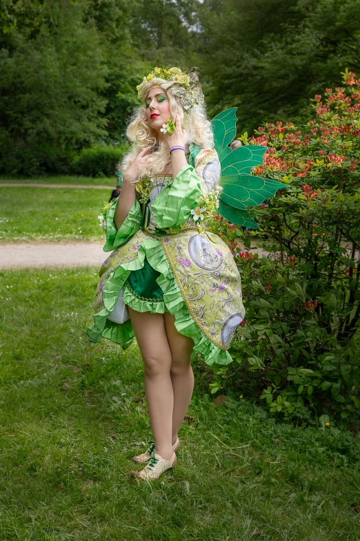 a woman dressed in a green and yellow fairy costume