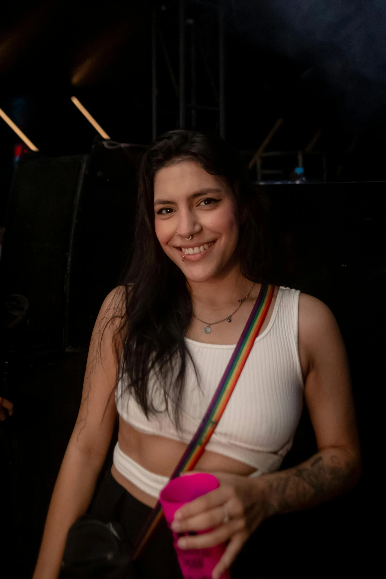 a girl posing for the camera with a cup