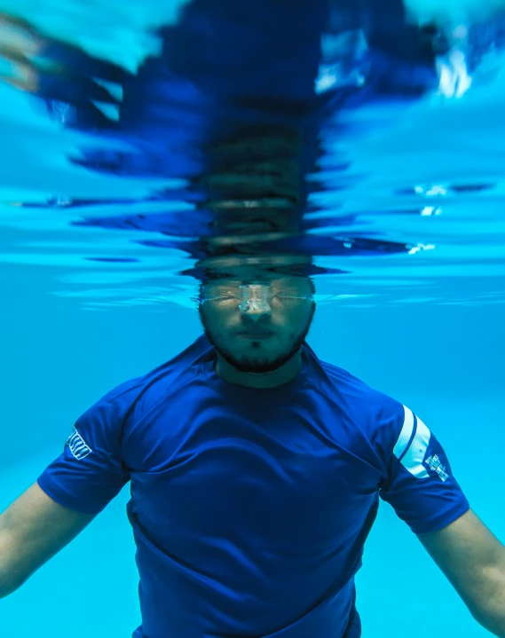 a person in a blue shirt underneath the water