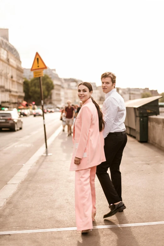 two people are standing outside in the rain