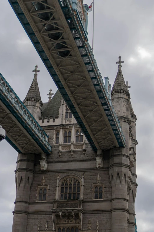 a very tall bridge with towers and a clock on it