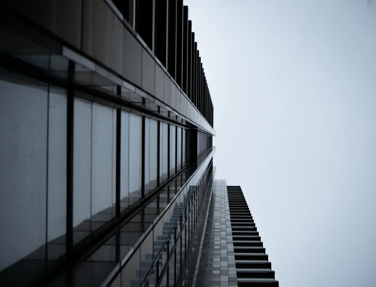 a tall skyscr standing against a cloudy sky