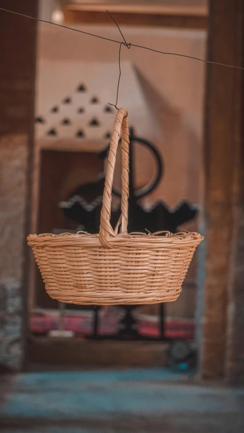 a handmade basket hanging off the side of a building