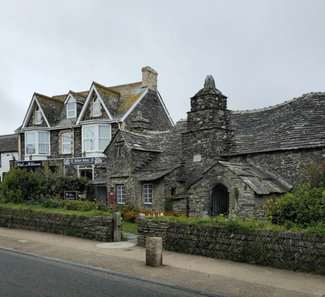 a house with two towers and two gardens surrounding it