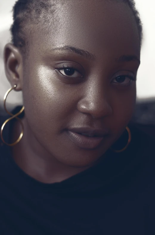 an african woman wearing large gold hoop earrings